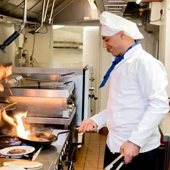 Sequoia Grove Chef Created Meals, chef frying a dish.
