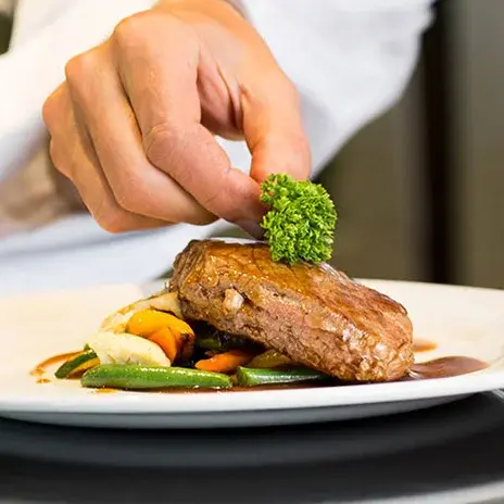 Sequoia Grove Chef Created Meals, chef garnishing a plate.