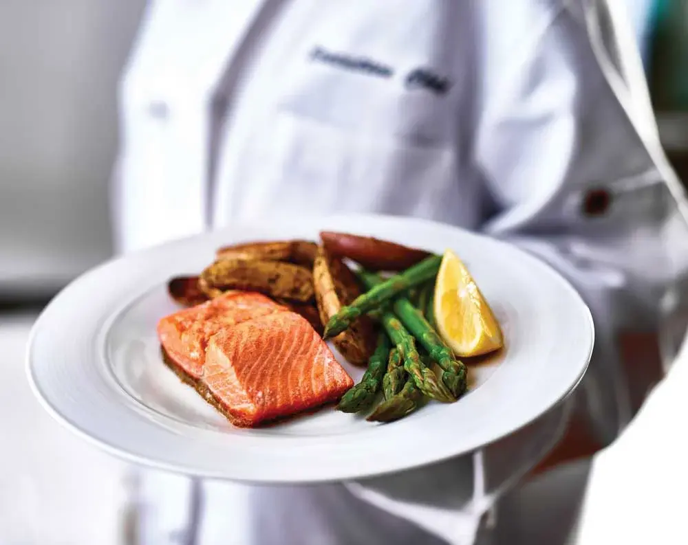 Sequoia Grove Chef Created Meals, chef delivering a finished dish.
