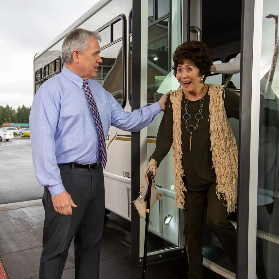 Sequoia Grove man helping lady off bus